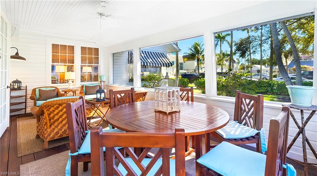 187 Broad Avenue South Naples, FL 34102 - Photo 10 of 33 a view of a dining room with furniture large windows and wooden floor