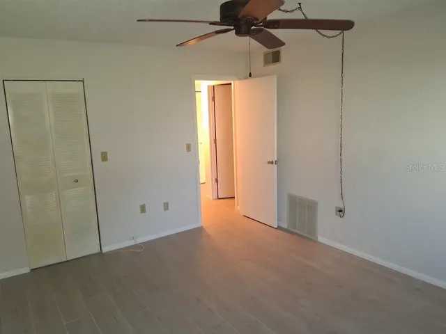 a view of empty room with a fan