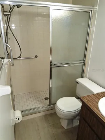 a white toilet sitting next to a shower