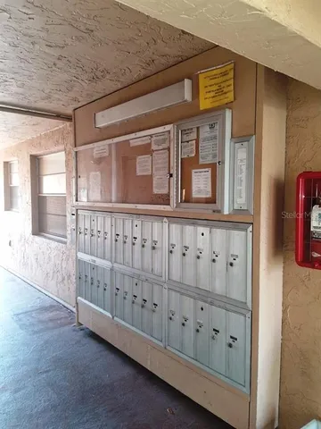 a view of a hallway with wooden floor and entryway
