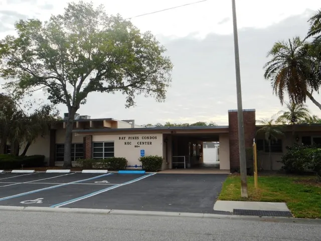 a room with wooden floor and pool table