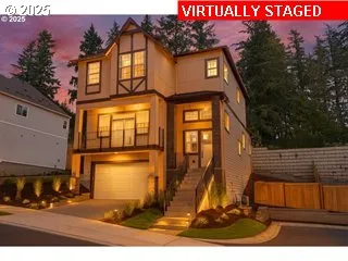 a view of a white house with large windows and a small yard