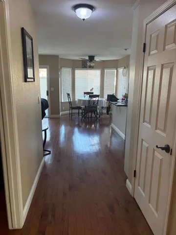 a view of a livingroom with furniture and hardwood floor