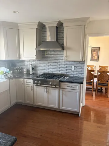 a kitchen with stainless steel appliances granite countertop a sink and cabinets
