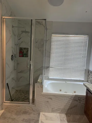 a bathroom with a bathtub and shower