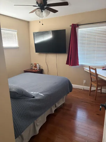 a bedroom with a bed and a chair