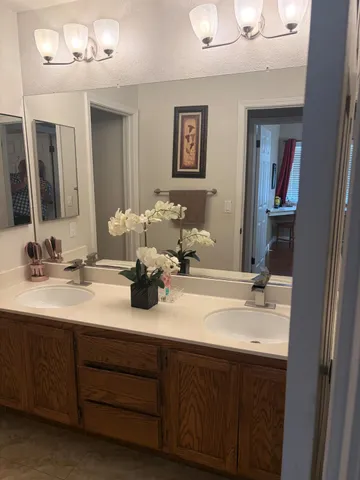 a bathroom with double vanity sinks and a mirror
