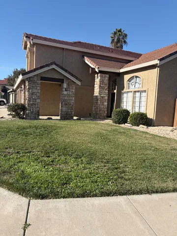 a front view of a house with a yard