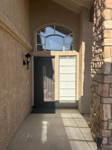a view of a house with a door and wooden floor