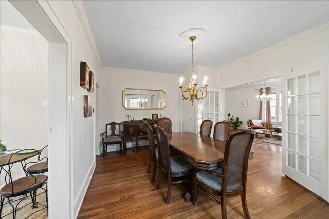 a view of a a dining room with furniture window and wooden floor