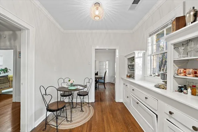a kitchen with stainless steel appliances a dining table chairs and chandelier