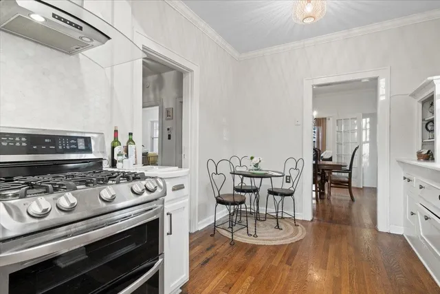 a kitchen with a stove a microwave and wooden floor