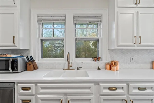 a large white kitchen with cabinets