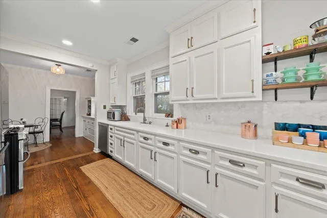 a view of a kitchen with a sink washer and dryer