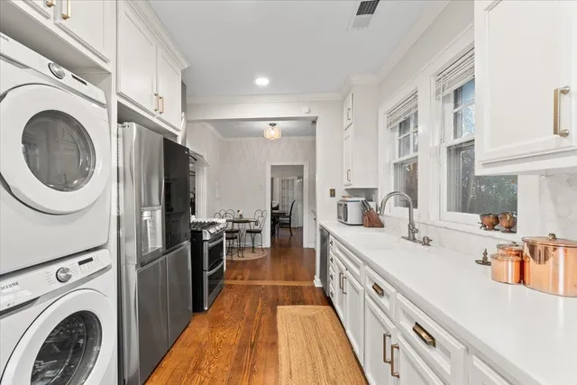a kitchen with stainless steel appliances granite countertop a stove and a refrigerator