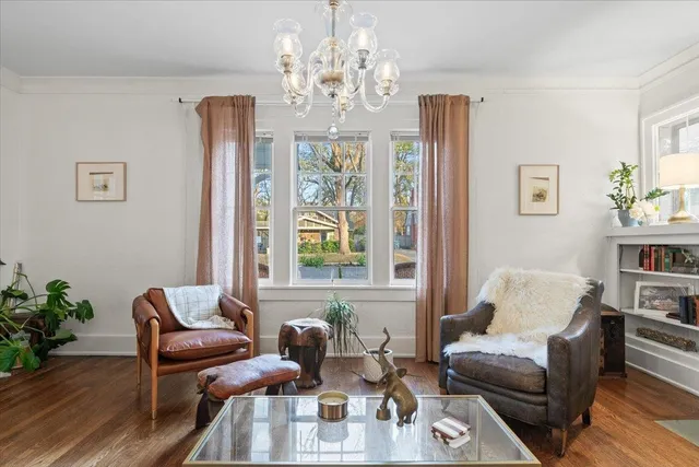 a living room with furniture and a chandelier