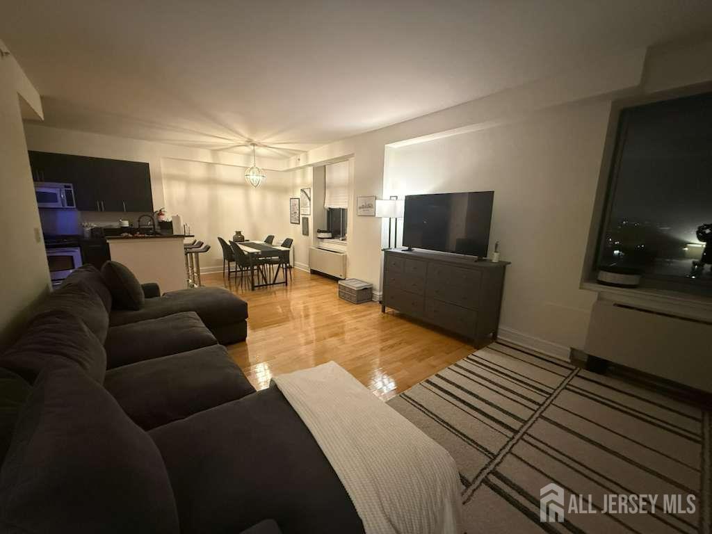 1 Spring Street, Unit 702 New Brunswick, NJ 08901 - Photo 4 of 10 a living room with furniture and a flat screen tv