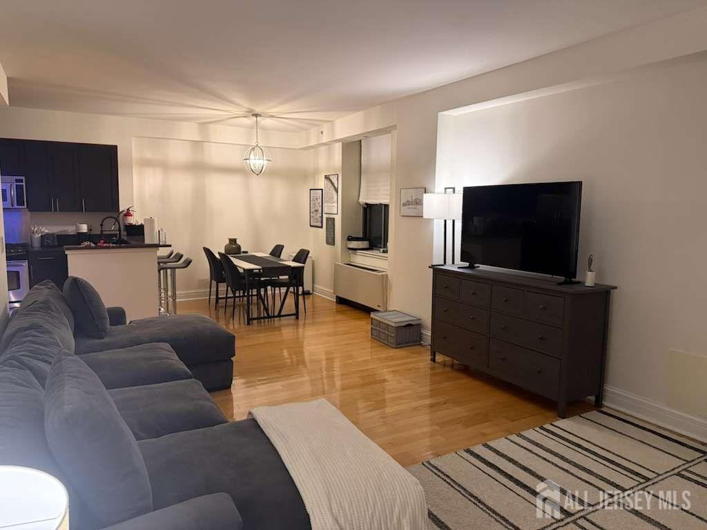 1 Spring Street, Unit 702 New Brunswick, NJ 08901 - Photo 5 of 10 a living room with furniture and a flat screen tv