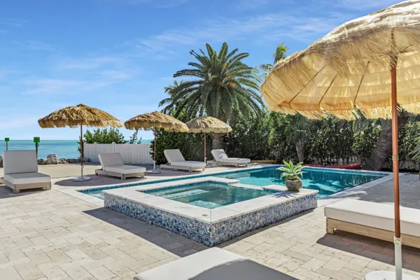 a view of a house with swimming pool and sitting area