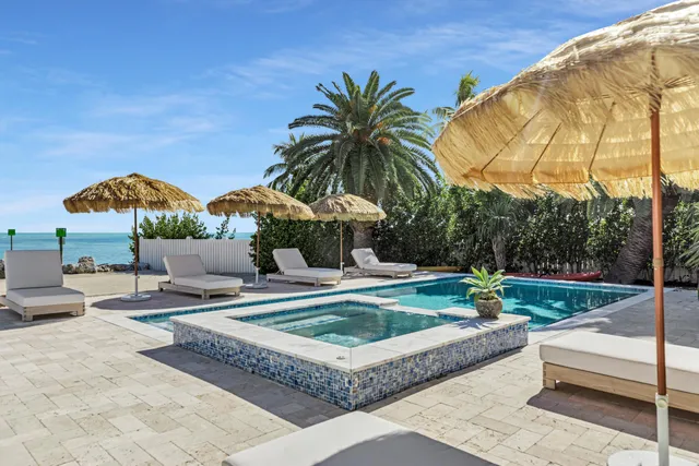 a view of a house with swimming pool and sitting area