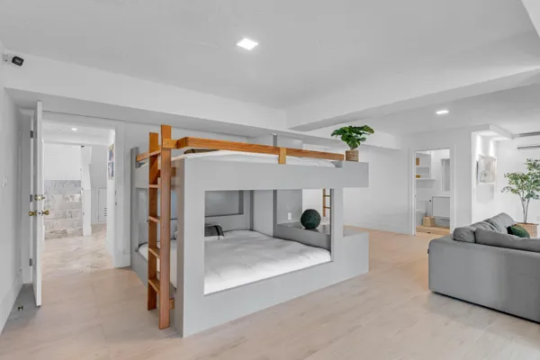 a bedroom with a bed and a chandelier