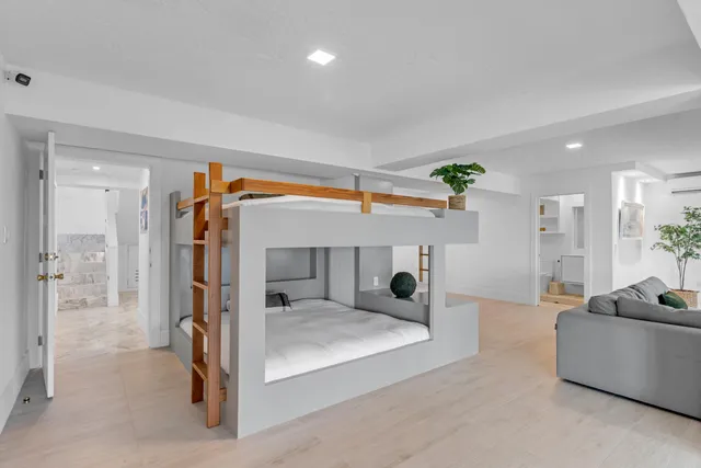 a bedroom with a bed and a chandelier