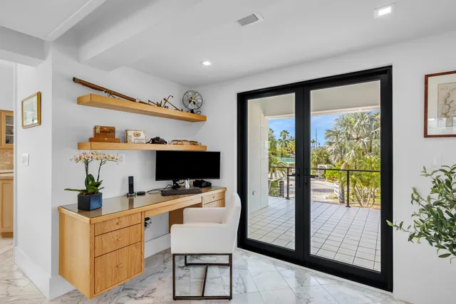 a bedroom with a large bed and a large window