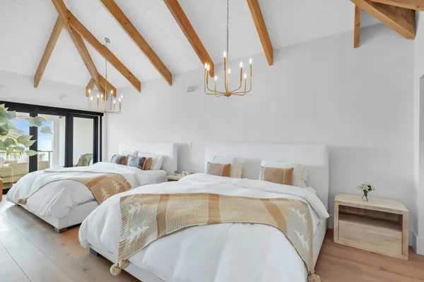 a bedroom with bed and wooden floor