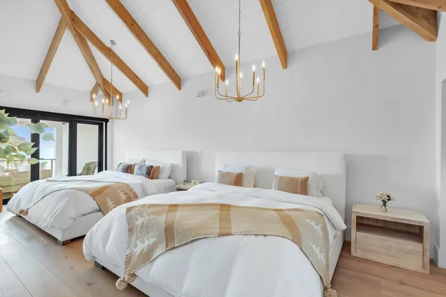 a bedroom with bed and wooden floor