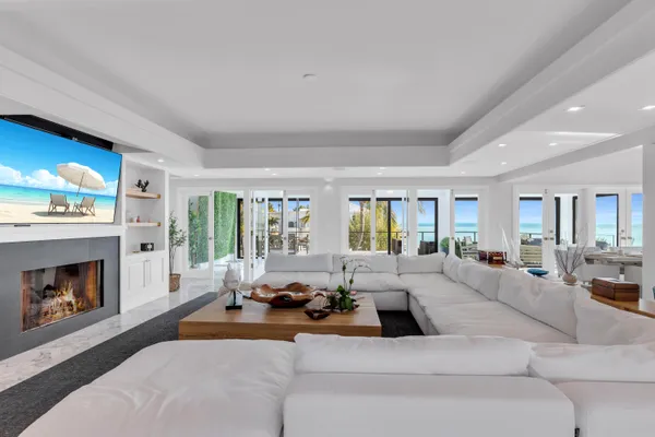 a living room with furniture large window and a fireplace