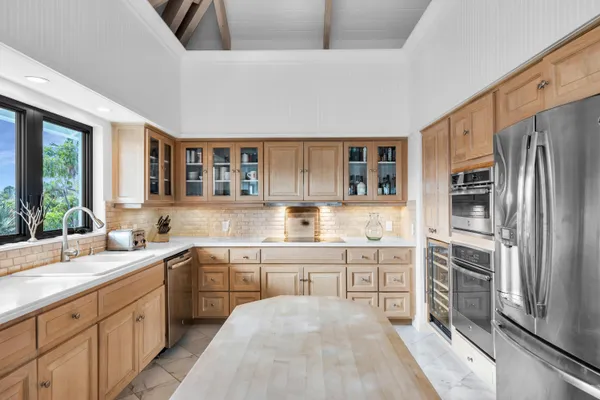 a kitchen with stainless steel appliances granite countertop a sink and dishwasher with wooden floor