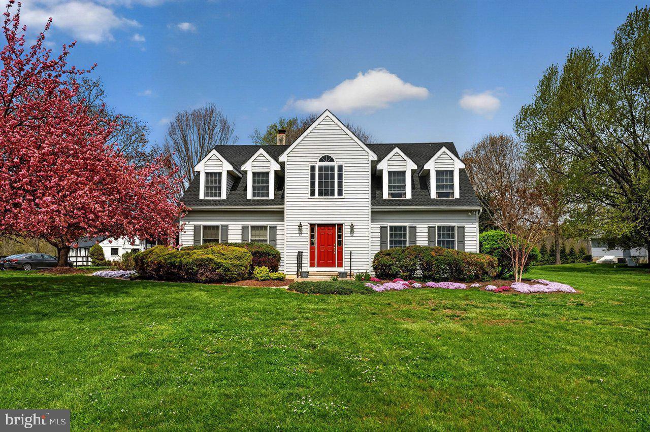 Charming home with vibrant landscaping.