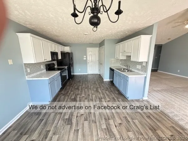 a kitchen with a sink stainless steel appliances and cabinets