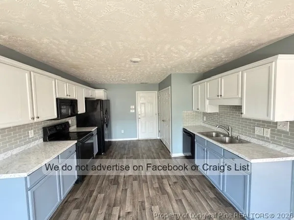 a kitchen with stainless steel appliances granite countertop a stove and a sink