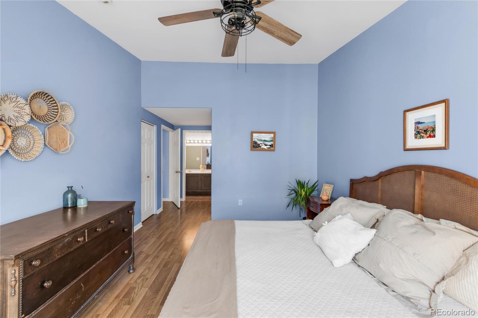 8405 Pebble Creek Way, Unit 202 Highlands Ranch, CO 80126 - Photo 12 of 27 a bedroom with a bed and a chandelier