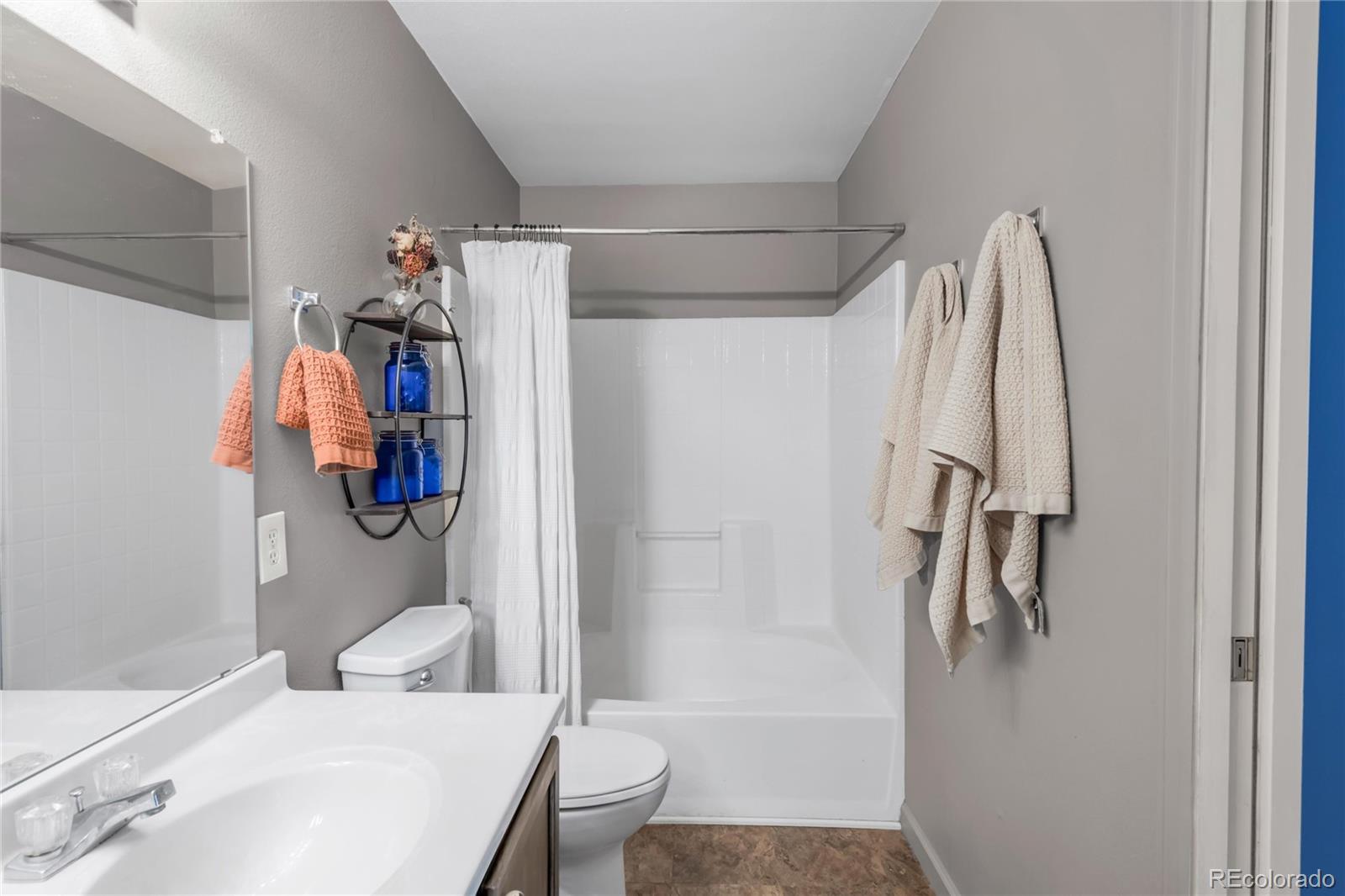 8405 Pebble Creek Way, Unit 202 Highlands Ranch, CO 80126 - Photo 14 of 27 a bathroom with a sink toilet and shower
