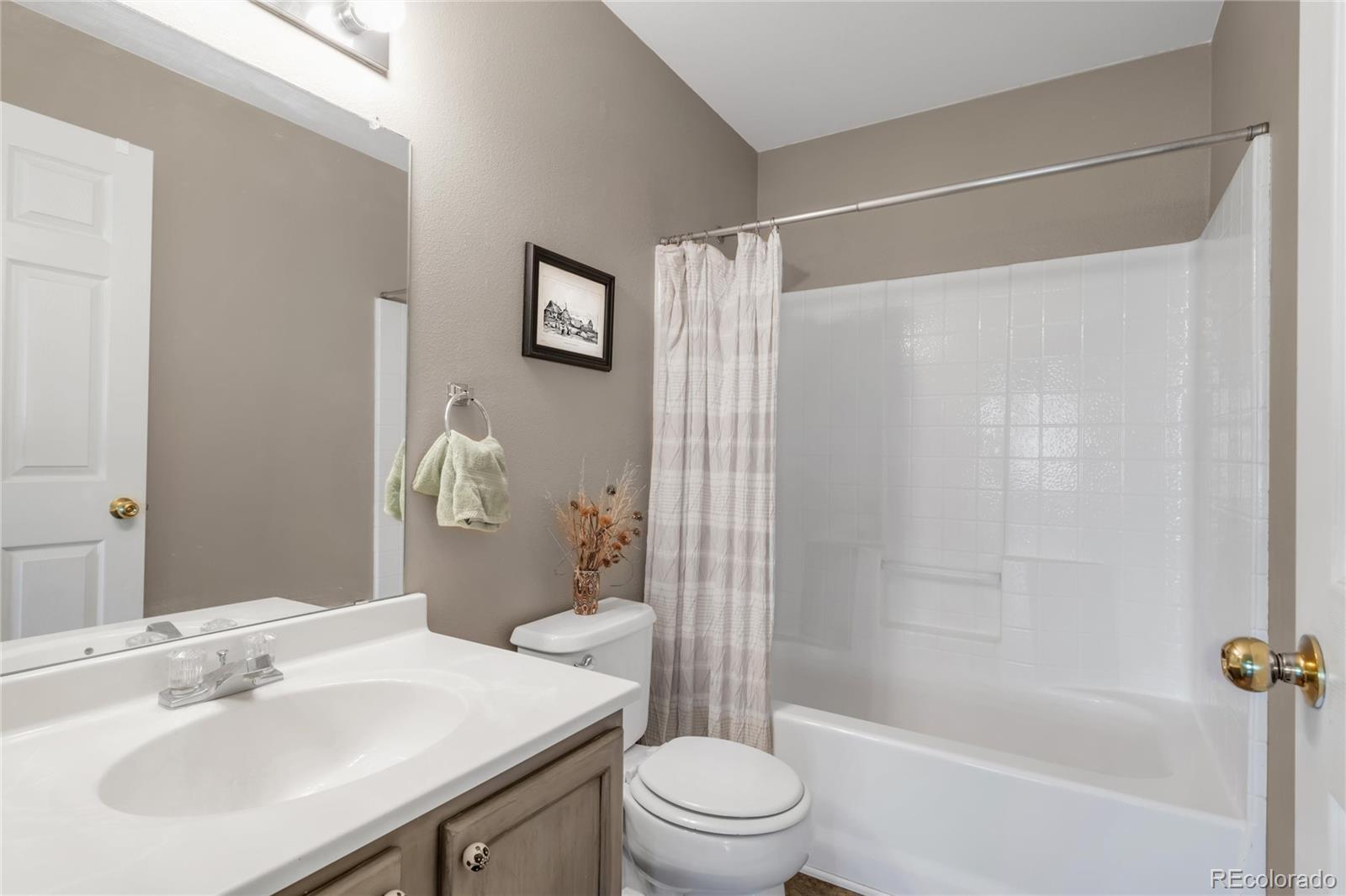 8405 Pebble Creek Way, Unit 202 Highlands Ranch, CO 80126 - Photo 19 of 27 a bathroom with a sink toilet and shower