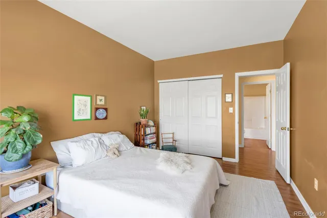 a bedroom with a bed and a potted plant