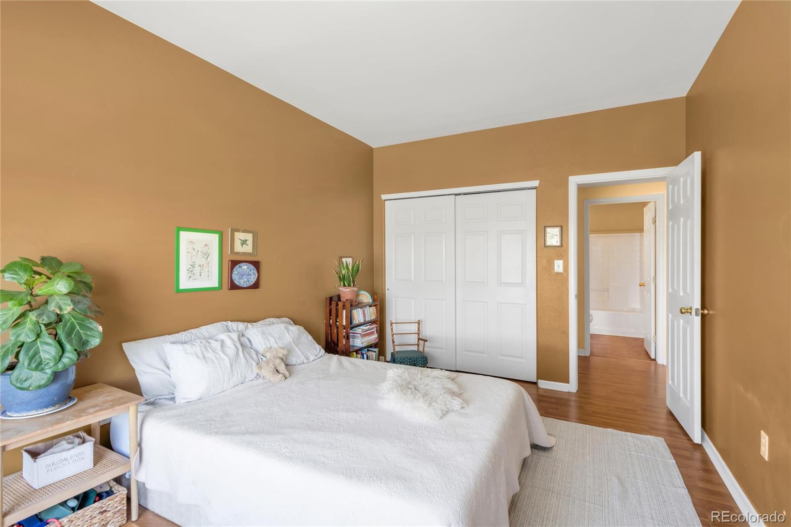 8405 Pebble Creek Way, Unit 202 Highlands Ranch, CO 80126 - Photo 21 of 27 a bedroom with a bed and a potted plant