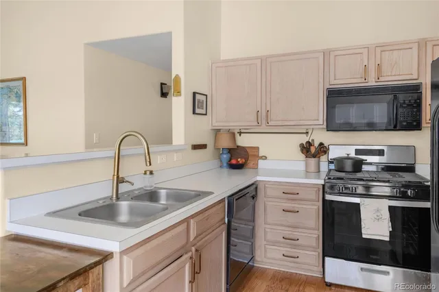 a kitchen with cabinets appliances a sink and a counter top space