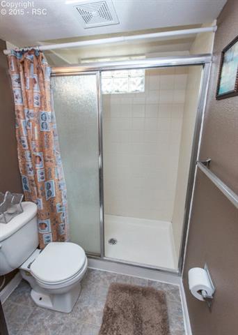 2007 North Chelton Road Colorado Springs, CO 80909 - Photo 27 of 35 This bathroom's shower is unique with its sliding glass door.