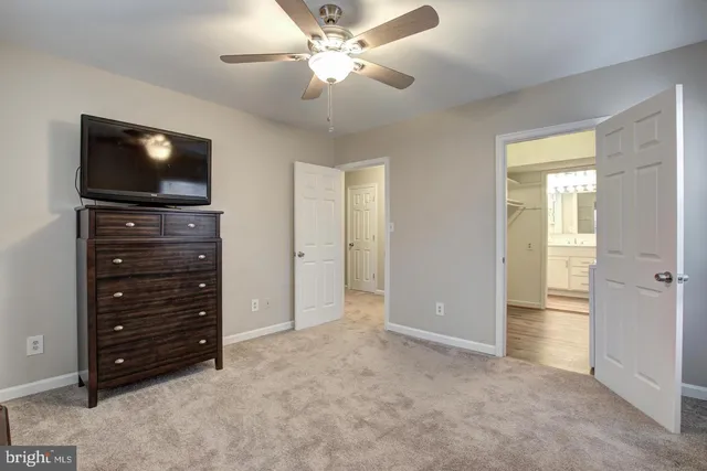 a view of room with closet and flat screen tv