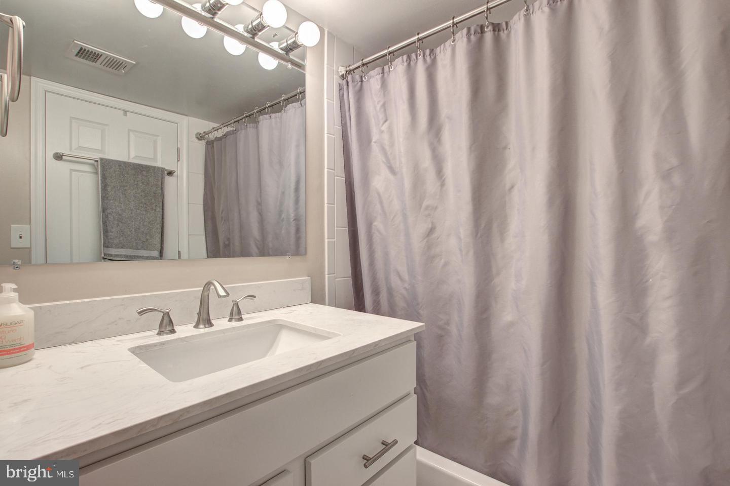 8354 G Dunham Court, Unit 655 Springfield, VA 22152 - Photo 16 of 19 a bathroom with a sink and a mirror