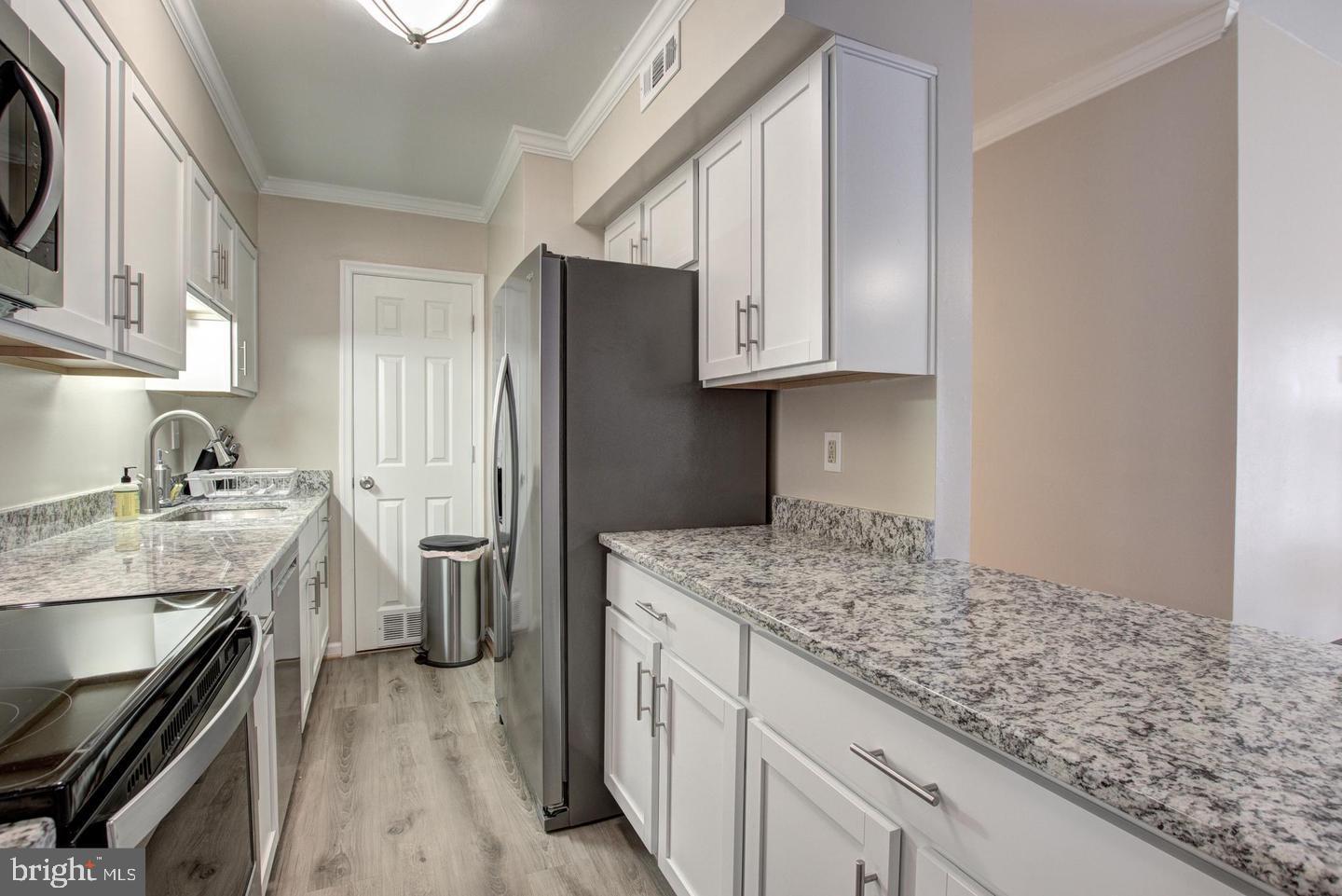 8354 G Dunham Court, Unit 655 Springfield, VA 22152 - Photo 10 of 19 a kitchen with a sink stove and refrigerator