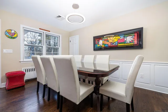 a view of a dining room with furniture and wooden floor