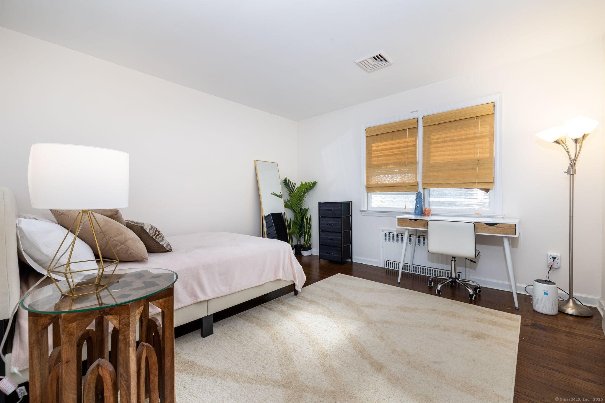 2 Columbine Lane Norwalk, CT 06851 - Photo 17 of 33 a bedroom with a bed and wooden floor