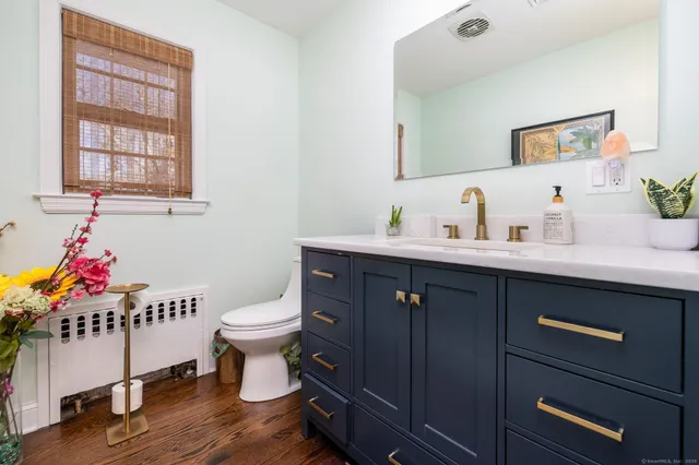 a bathroom with a sink mirror and toilet