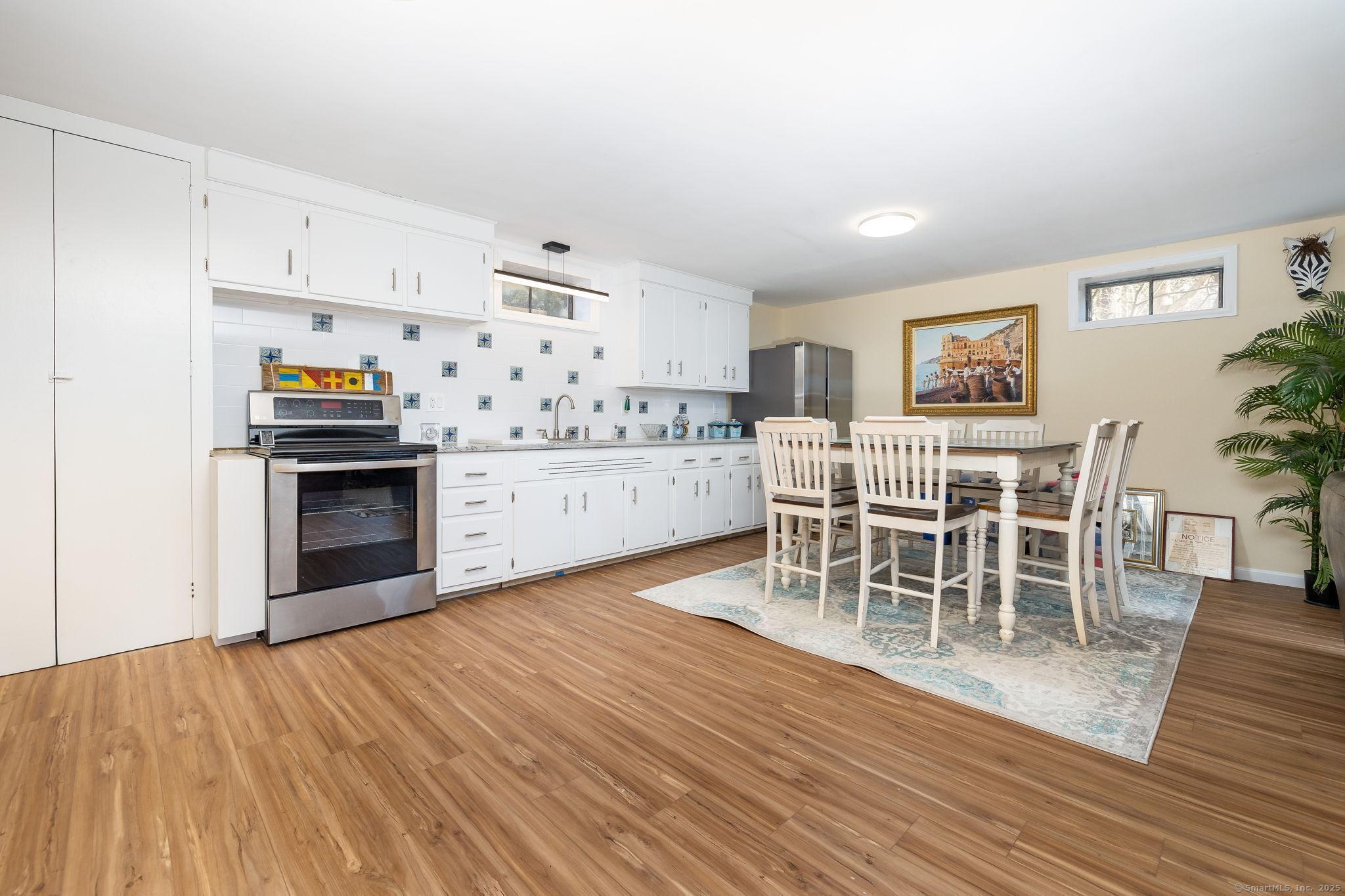 2 Columbine Lane Norwalk, CT 06851 - Photo 21 of 33 a living room with stainless steel appliances furniture a large window and wooden floor
