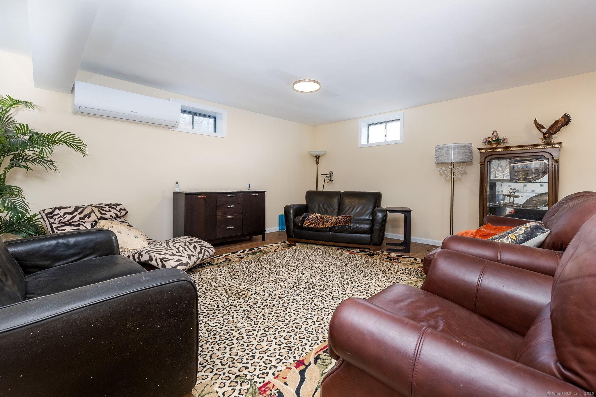 2 Columbine Lane Norwalk, CT 06851 - Photo 24 of 33 a living room with furniture and a flat screen tv