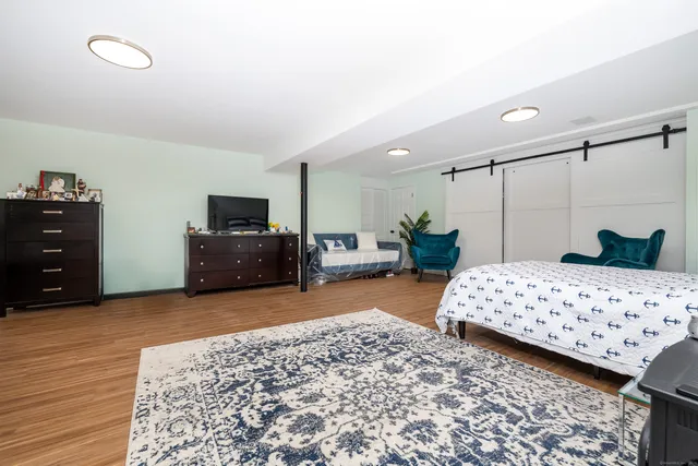 a bedroom with a bed and a television